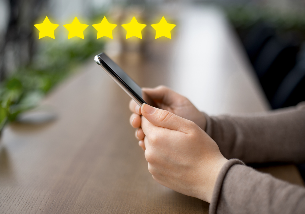 An image of a hand with five stars indicating an online rating